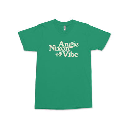 Green short-sleeve cotton tee with "Angie Nixon Is the Vibe" text in cream centered on front.