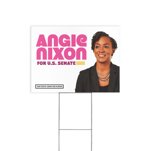 White rectangular yard sign with bold pink and yellow text reading "ANGIE NIXON FOR U.S.