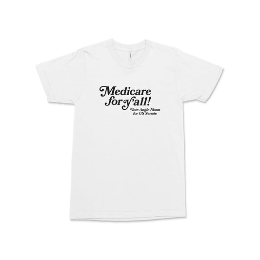 White unisex crewneck t-shirt with black text "Medicare for Y'all! Angie Nixon for U.S. Senate" centered on front.